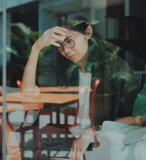 entrepreneure sensible la main sur le front, semblant épuisée, symbolisant la surcharge mentale en business